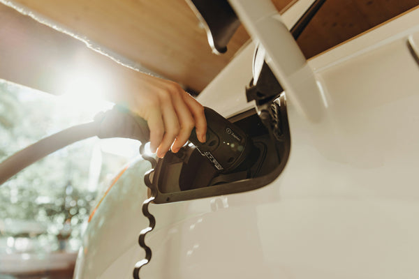 A white electric car being charged with a Zaptec charger